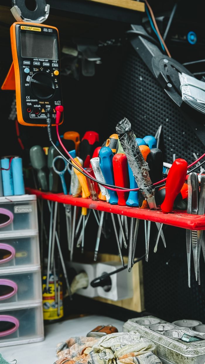 Mastering the First Impression: Your intriguing post title goes here Neatly arranged tools on a workbench, featuring pliers, screwdrivers, and a multimeter.