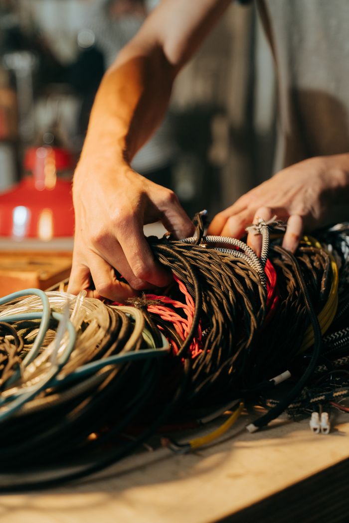 The Art of Drawing Readers In: Your attractive post title goes here Close-up of hands sorting through a collection of colorful wires and cables.
